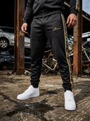 ROLLEMAN Ravi Trainingshose – Schwarz / Amber Gold
